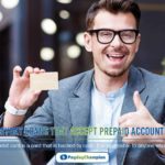 A man sitting at a table with a laptop giving a thumbs up for payday loans that accept prepaid accounts