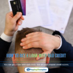 A man holding a credit card over his head thinking how to get a loan with bad credit