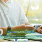 A businessman using his laptop to search what is a bad credit score and how can I build it up further