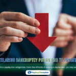 A person holding a red paper arrow in their hand representing declaring bankruptcy put an end to payday loans