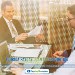 A couple of men sitting at a desk in front of a monitor discussing Florida payday loan consolidation