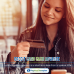 A woman holding a credit card cash advance and a smart phone