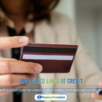 A person holding a credit card and a cell phone to reading about unsecured lines of credit