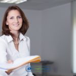 A woman in a white shirt submitting a credit builder loan application form