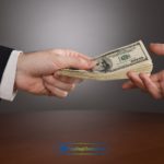 a person handing money to another person
