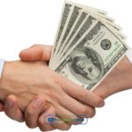 Two people shaking hands over a stack of money from installment loans in Delaware