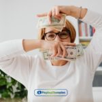 a person holding a dollar bill in their hand.