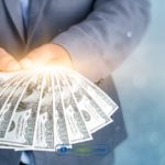 A person holding dollar bills from installment loans in South Carolina