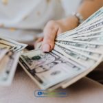 A person counting money from installment loans from Tennessee