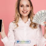 a person holding a dollar bill & a phone in their hand.