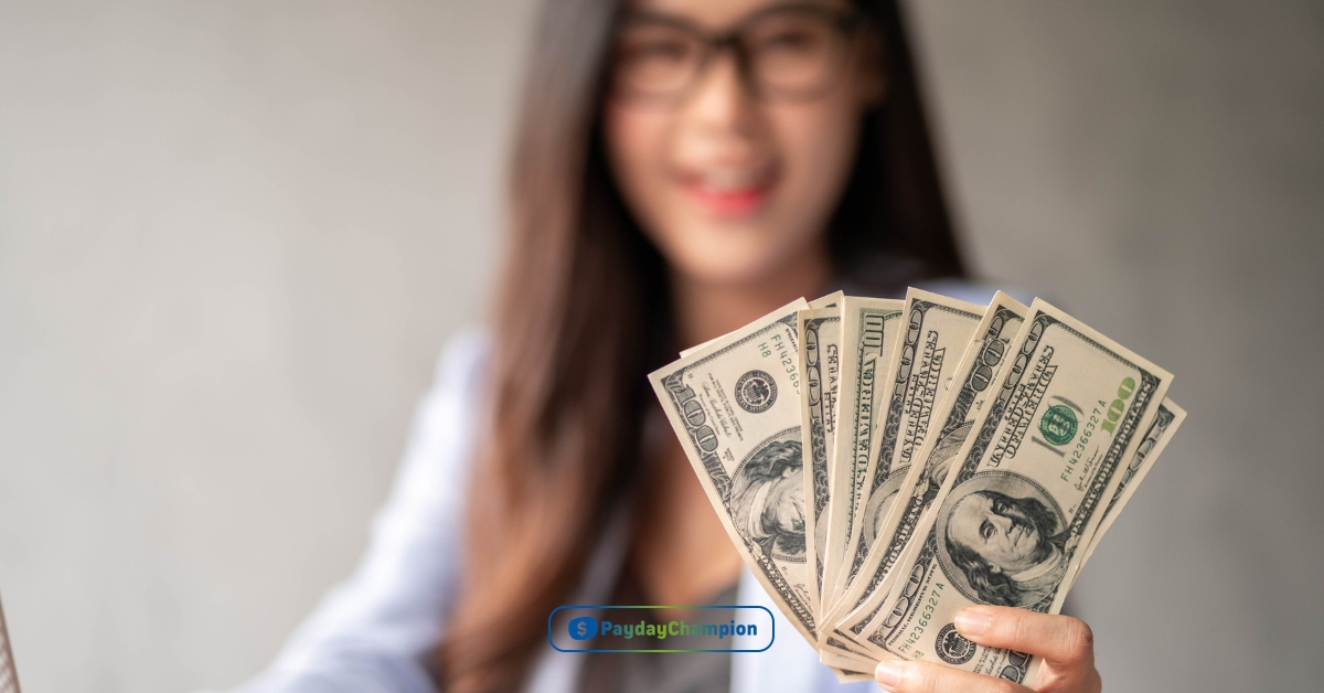 a person holding a dollar bill in their hand.