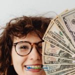 A woman in Indiana holding a bunch of money from online installment loans