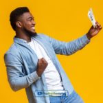 A man holding a piece of online installment loans agreement paper in Minnesota in his hand