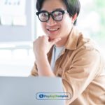 A person sitting at a desk with a laptop learning how Direct Plus loans work