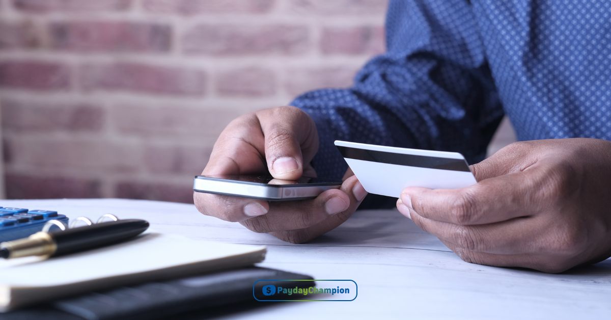 A man holding a credit card and smart phone searching for installment credit definition, benefits and strategies