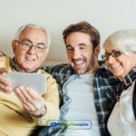 A couple of people sitting on a couch after obtaining parent loans online