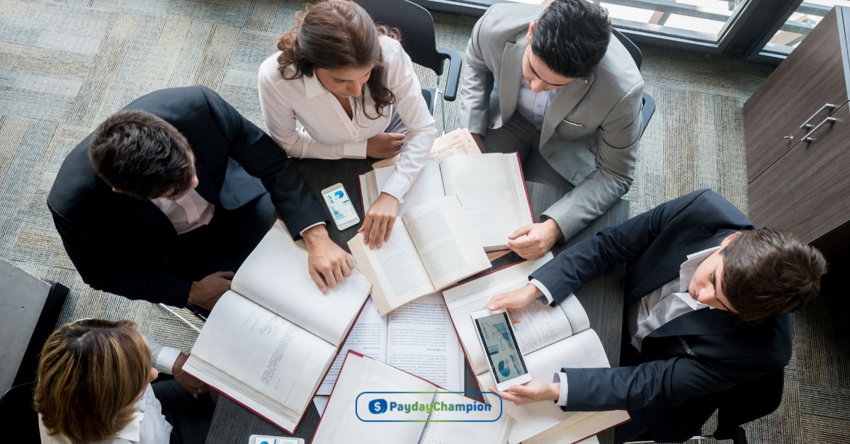 A group of borrowers with co-signers sitting around a table discussing the pros and cons of the loan