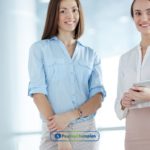 Two women standing next to each other in payday loans office in Jacksonville