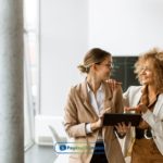 A couple of women standing next to each other applying online for payday loans Nashville