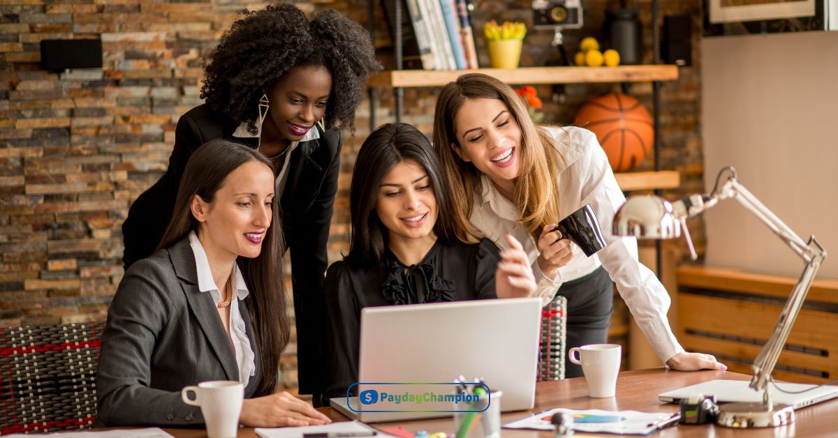 A group of women sitting at a table looking at a laptop reading about payday loans in San Antonio