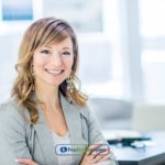 A woman standing in payday loans San Jose office with her arms crossed