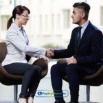 A man and woman shaking hands in a chair to get payday loan with no job