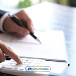 A person is writing on a piece of paper while using a calculator about limitations on a payday loan